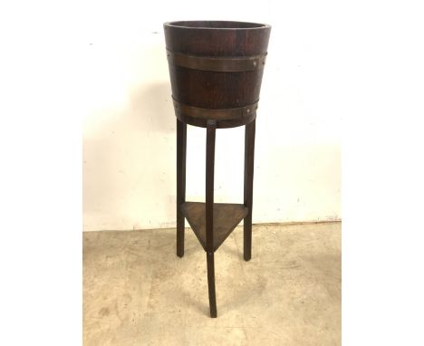 An early 20th century oak Lister style coopered jardiniere with lower shelf. H:91cm