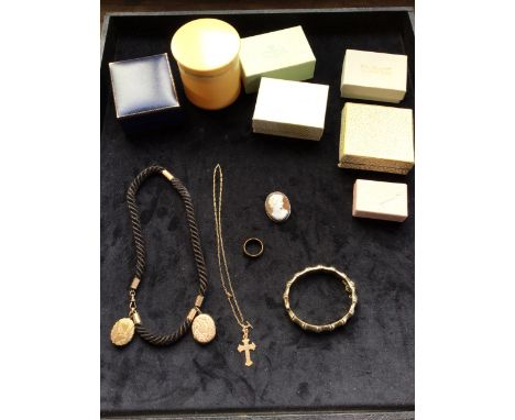 A nine carat gold crucifix and chain weight 3 gm, a yellow metal bangle weight 15gm with silver hall mark, a silver cameo bro