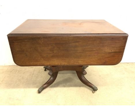 A Georgian mahogany sofa table with drawers to both ends. With fluted column to base with brass bird claw feet on castors.  W