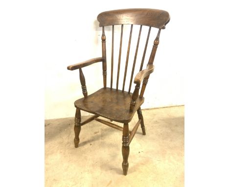 A late 19th early 20th century elm seated kitchen stick back arm chair.  A.F Loose arm. W:58cm x D:60cm x H:107cm