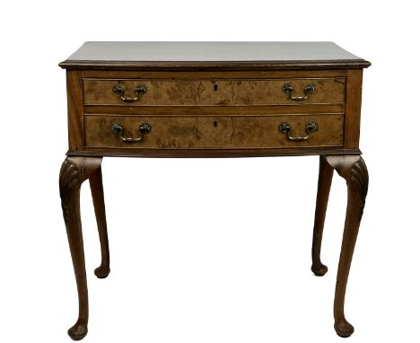 Silver twelve setting canteen of cutlery, housed in a walnut two drawer side table raised on cabriole and shell supports L81c