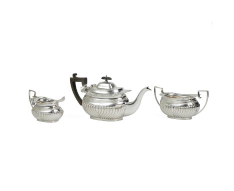 Silver three piece tea set comprising of a teapot, H14cm, milk jug and sugar bowl all with gadroon and shell decoration to th