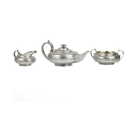 Georgian silver gilt three piece tea set, the bodies decorated with acanthus, garlands of flower and a crest with crown and s
