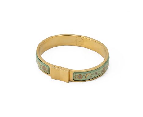 Hermes gilt bangle, the two panels decorated with moons and shooting stars, the inner section stamped "Hermes", with original