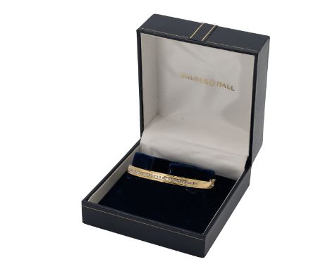 18ct gold, diamond set hinged bangle, the channel set small brilliants totalling approximately 0.5 carats, inner diameter 5.8