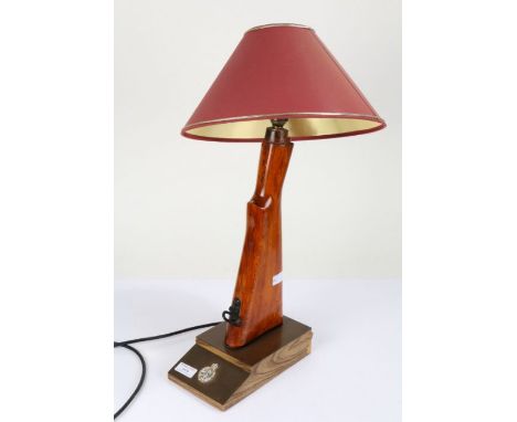 Novelty table lamp created out of the stock of a rifle, with an insignia to the base, 39cm high