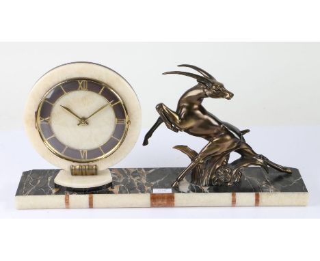 Art Deco style mantel clock, the dial with a white onyx surround and Roman numerals, flanked by a stylised gazelle, raised on