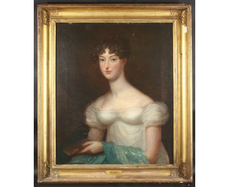 EARLY 19TH CENTURY ENGLISH SCHOOL A portrait of a seated lady holding a book, thought to be Ann Philips, oil on canvas. 30" x