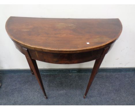 A 19th century inlaid mahogany D-shaped turn over top card table.