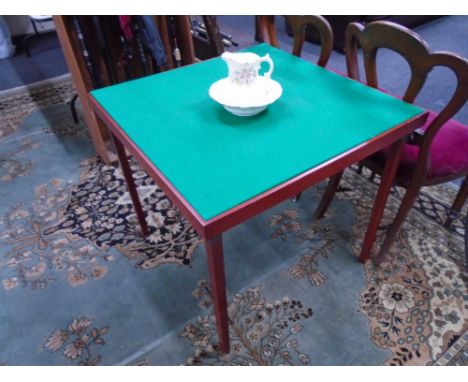 A folding baize topped card table together with a Tyne potteries floral pattern jug and basin.