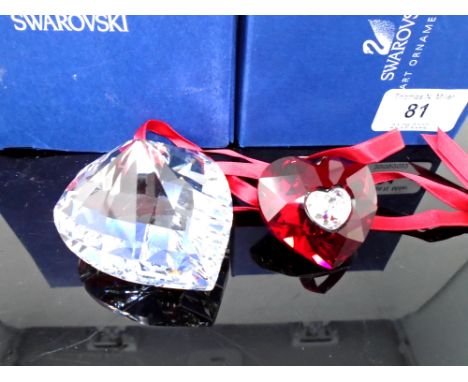 A Swarovski crystal ornament, heart together with a further Swarovski ruby heart pendant on ribbon.