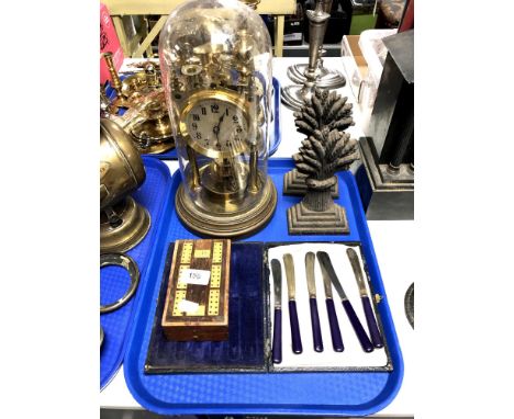 A tray containing a pair of 19th century wheat sheath door stops, cribbage board, cased butter knives, anniversary clock unde