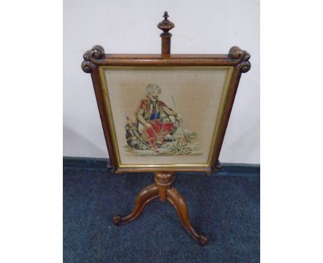 A Victorian rosewood tapestry pole screen on three-way pedestal.