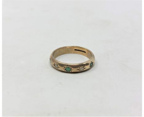 A 9ct yellow gold band ring set with emerald and diamonds, size J/K, 2.5g.