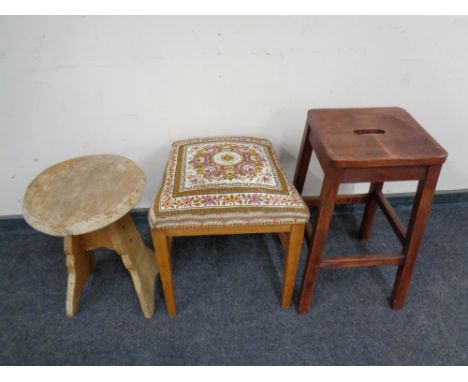 A tapestry upholstered stool together with two further stools.