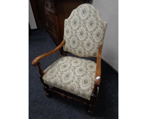 A 20th century beech armchair upholstered in tapestry fabric.