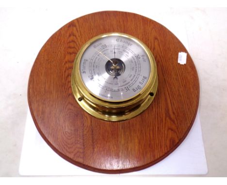 A Weathermaster barometer mounted on a board.