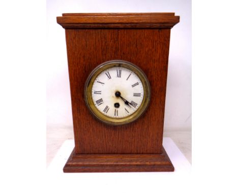 An Edwardian oak cased mantel clock.