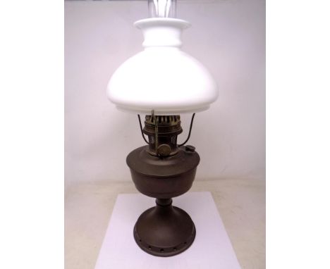 An Aladdin oil lamp with chimney and opaque glass shade.