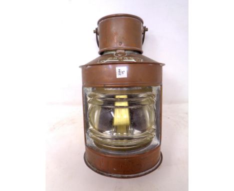 A copper cased miniature ships lamp.
