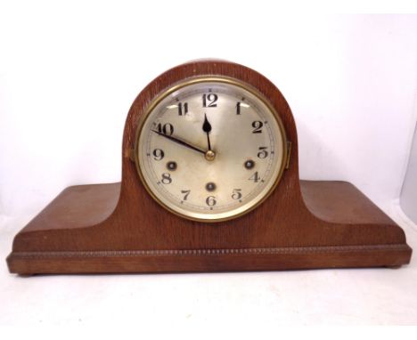 A 1930's oak cased Westminster chime mantel clock with silvered dial on bun feet.