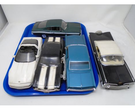 A tray containing five large scale die cast vehicles.