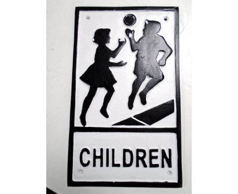 A cast iron wall plaque, children playing.