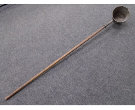 An antique long-handled smelters ladle (length 190cm).
