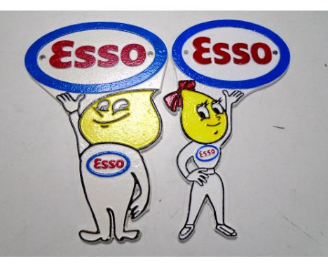 Two cast iron wall plaques, Esso, Andy and Abby slick.