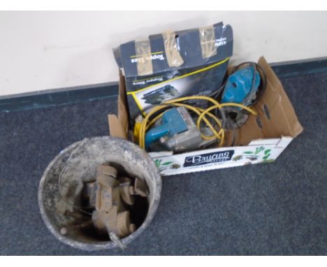 A box containing Wolf 110v planer, Makita router, tile cutter together with a plastic bucket containing two vices.