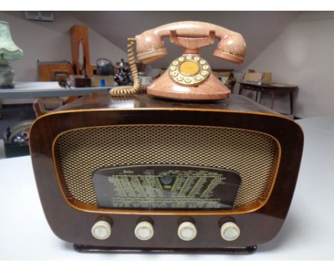 An Art Deco Merkur valve radio together with a retro style telephone.