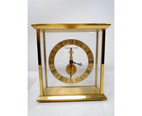 A brass cased Jaeger-LeCoultre desk clock with eight day inline movement, height 17cm, in original box with paperwork.