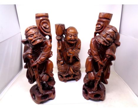 Three carved hardwood figural lamp bases of Chinese gentlemen.