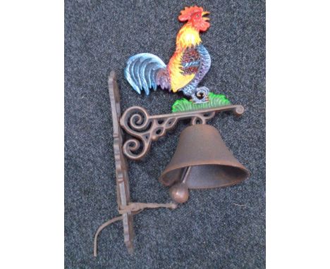 A cast iron cockerel wall bracket with bell.