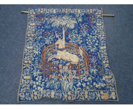 A tapestry wall hanging titled Licorne Captive, on brass pole, 96cm by 78cm.