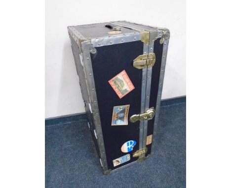 A shipping trunk bearing labels.