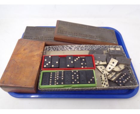 A tray containing vintage dominoes and cribbage pegboards.