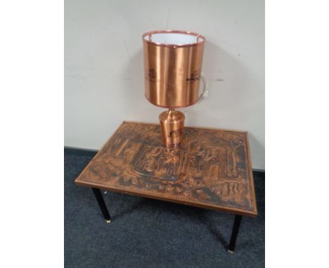 A rectangular African embossed copper top table depicting a traditional village scene together with a further copper table la