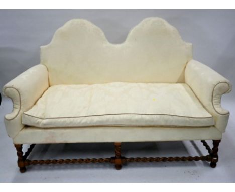 A traditional Queen Anne style double hump-back sofa, raised on six oak barley twist legs united by conforming stretchers, 16