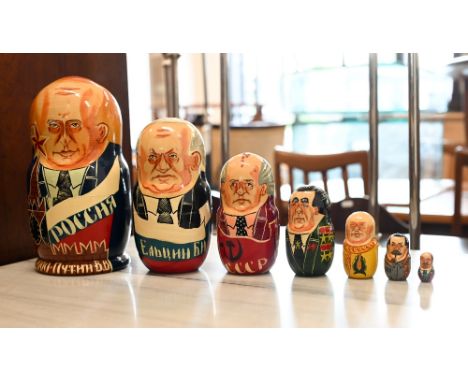 Nine various painted wood novelty Russian dolls, featuring Soviet presidents, British Prime Ministers, Royal Family, US presi