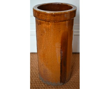 A cylindrical stoneware amber-glazed umbrella/stick stand, 49 cm high 