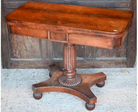 Regency rosewood folding card table, raised on a gadrooned support to a platform base, on castors, 92 x 46 x 74 cm h 