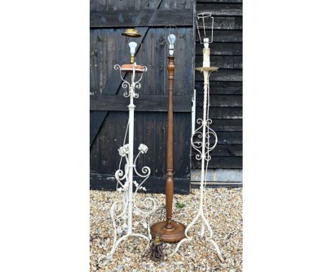 Two antique wrought iron/steel standard lamps, converted from an oil lamp and later painted, to/w a mahogany standard lamp an