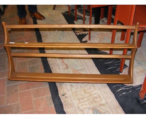 An Ercol wall hanging plate rack