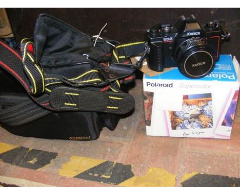 A Konica TC-X vintage camera in carry case together with a Polaroid super colour camera in box
