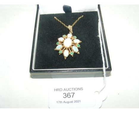 An opal and emerald pendant on chain