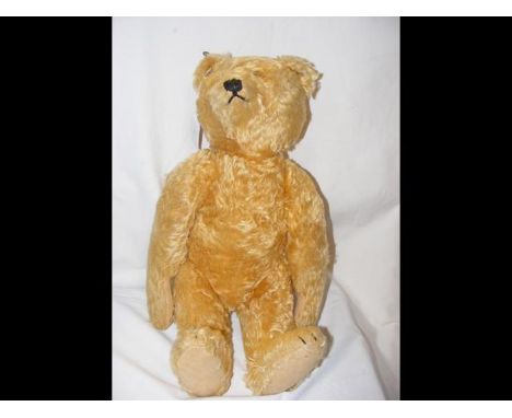 An old Steiff straw filled Teddy with glass eyes and button to left ear, with hump to back - the bear measuring 51cm long CON