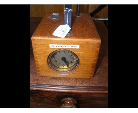 An F E Benzing pigeon racing clock in oak case 