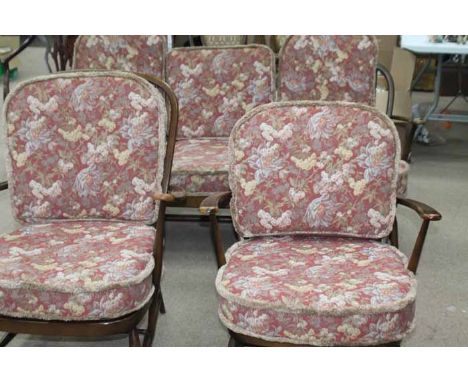 DARK ERCOL 'WINDOR' SUITE
comprising two armchairs and a three seater settee, cushions in pink floral upholstery, with origin