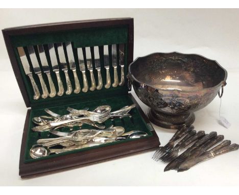 Large silver plated punch bowl with embossed floral decoration and lion mask swing handles, together with a canteen of George